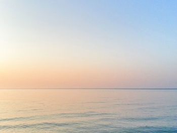 Scenic view of sea against clear sky during sunset 