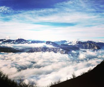 Scenic view of clouds and mountains against sky