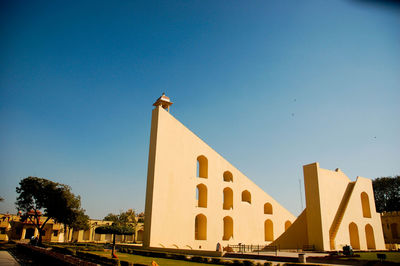 Low angle view of building against blue sky