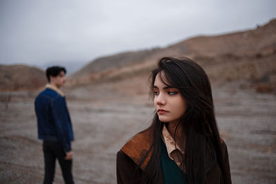 Portrait of a young couple standing in desert