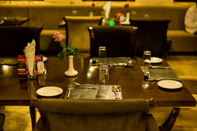 Empty chairs and tables in restaurant