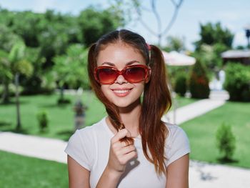 Young woman wearing sunglasses standing outdoors