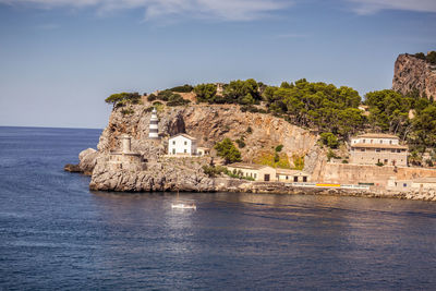 Building by sea against sky