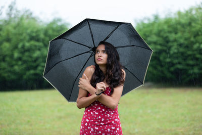 Young woman holding umbrella