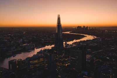 Shard london bridge amidst cityscape during sunset