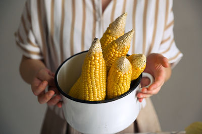 Midsection of woman holding ice cream in bowl