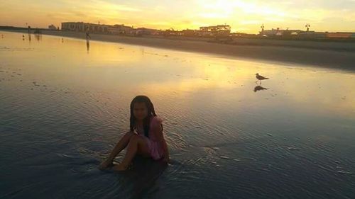 People in water at sunset