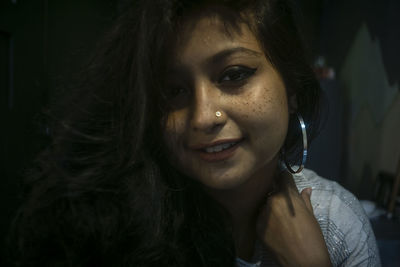 Close-up portrait of smiling young woman