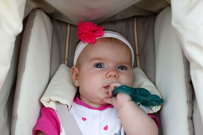 Close-up portrait of cute baby girl in carriage