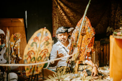 Portrait of young man in market stall