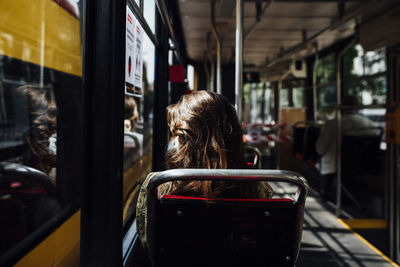 Rear view of woman in train