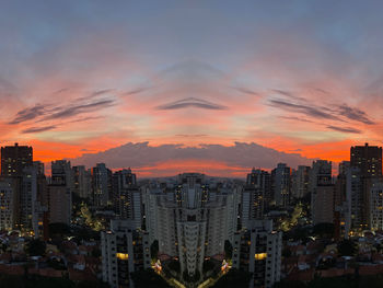 Illuminated buildings against sky during sunset
