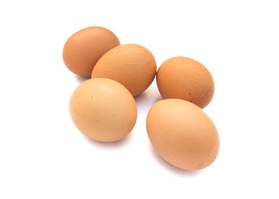 Close-up of eggs against white background