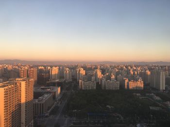 High angle shot of illuminated cityscape against clear sky