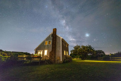 Built structure on field against sky at night