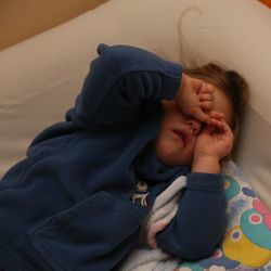 High angle view of cute girl sleeping on sofa at home