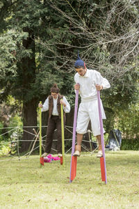 Full length of men playing on grassland