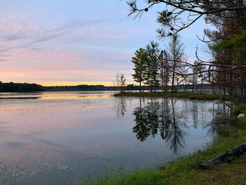 Scenic view of lake against sky at sunset