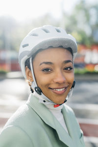 Smiling businesswoman wearing cycling helmet