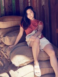 Young woman sitting on sofa at home