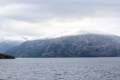 Scenic view of sea and mountains against sky