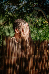 Midsection of man with arms raised plants