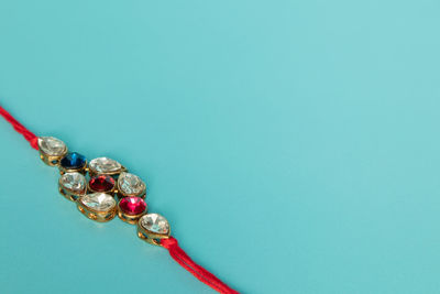 Close-up of necklace on blue background