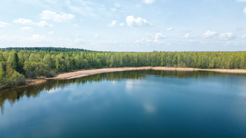 Beautiful summer landscape, calm surface of the lake, forest, sandy shore. aerial photography.