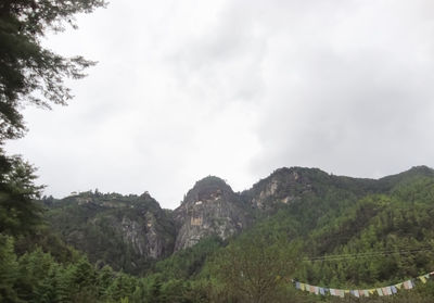 Low angle view of mountain against cloudy sky