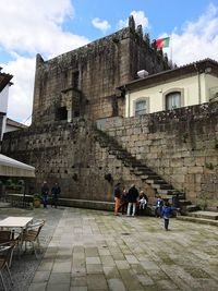 People on steps of historical building