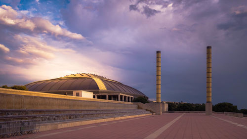 View of factory against sky at sunset