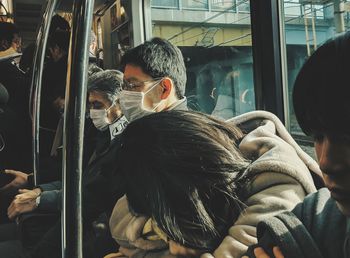 Rear view of people relaxing in train