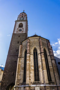 Low angle view of bell tower against sky