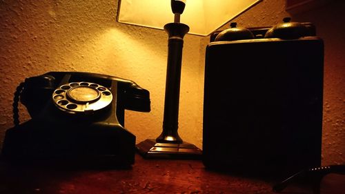 Close-up of illuminated electric lamp on table