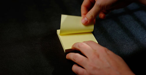 Cropped hand of woman holding paper