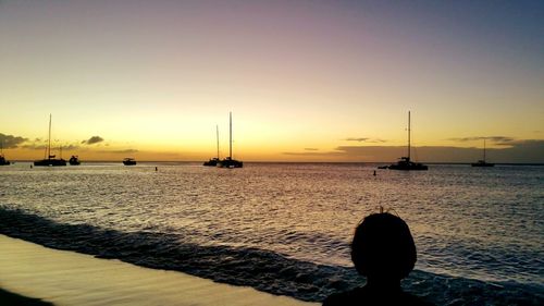 Silhouette of man in sea during sunset