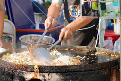 Midsection of man preparing food