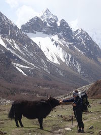 Full length of people on snowcapped mountains during winter