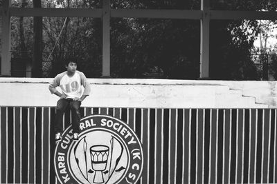 Man sitting on retaining wall