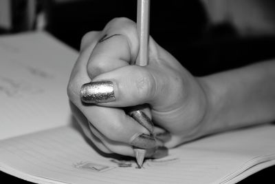 Close-up of hand holding book