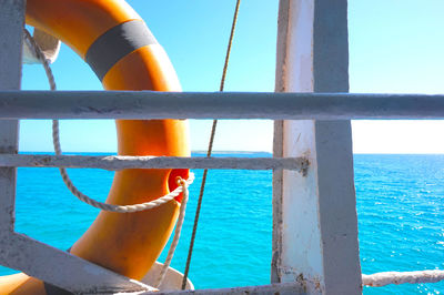 Close-up of rope tied to sea against sky