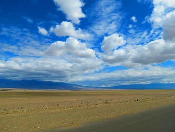 Scenic view of landscape against cloudy sky