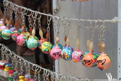 Close-up of various key rings hanging for sale in market