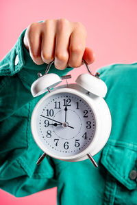 Midsection of man holding pocket watch