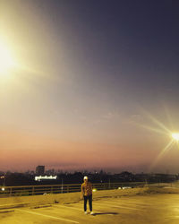 Full length of man standing against sky during sunset