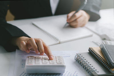 Midsection of woman working on table