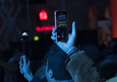 Man photographing with mobile phone