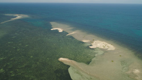 Tropical island with white sandy beach. aerial view of sandy cory island with colorful reef. 