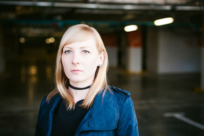 Close-up portrait of woman standing in basement