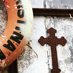 Close-up of cross on rusty metal